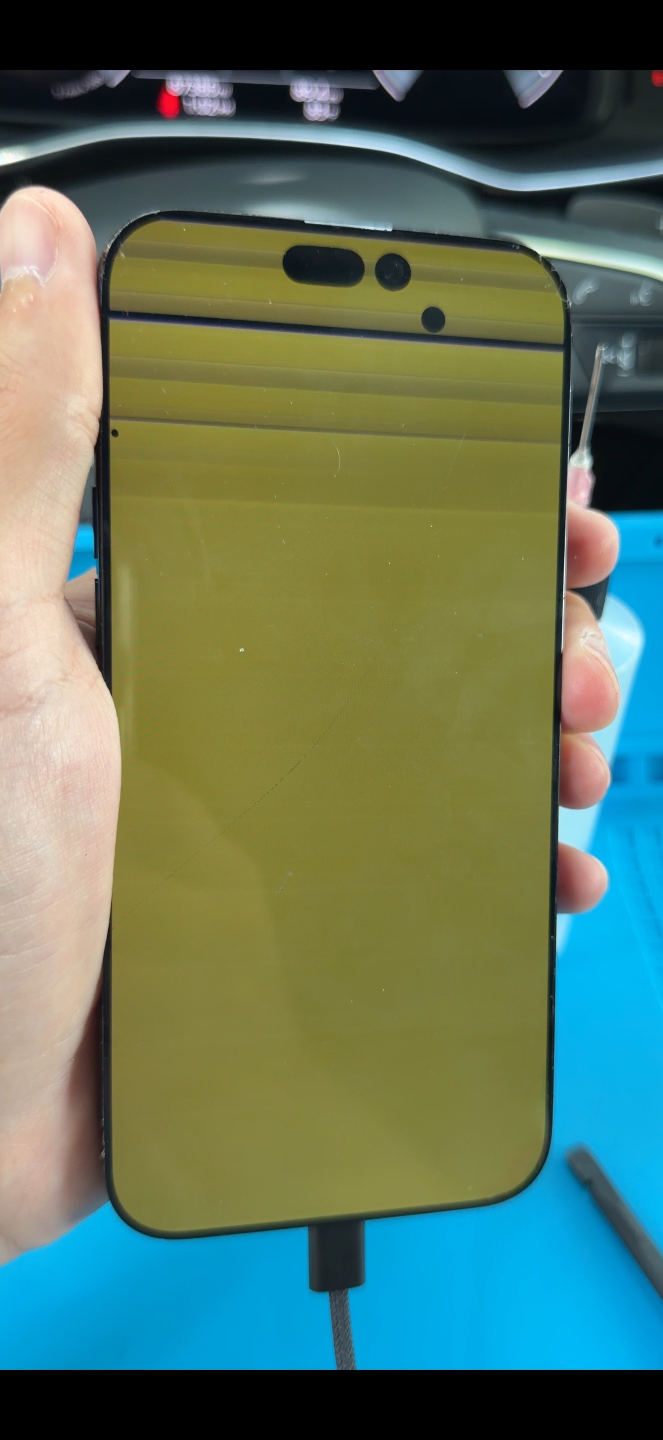 Before repair: damaged iPhone display with yellow screen issue and lines