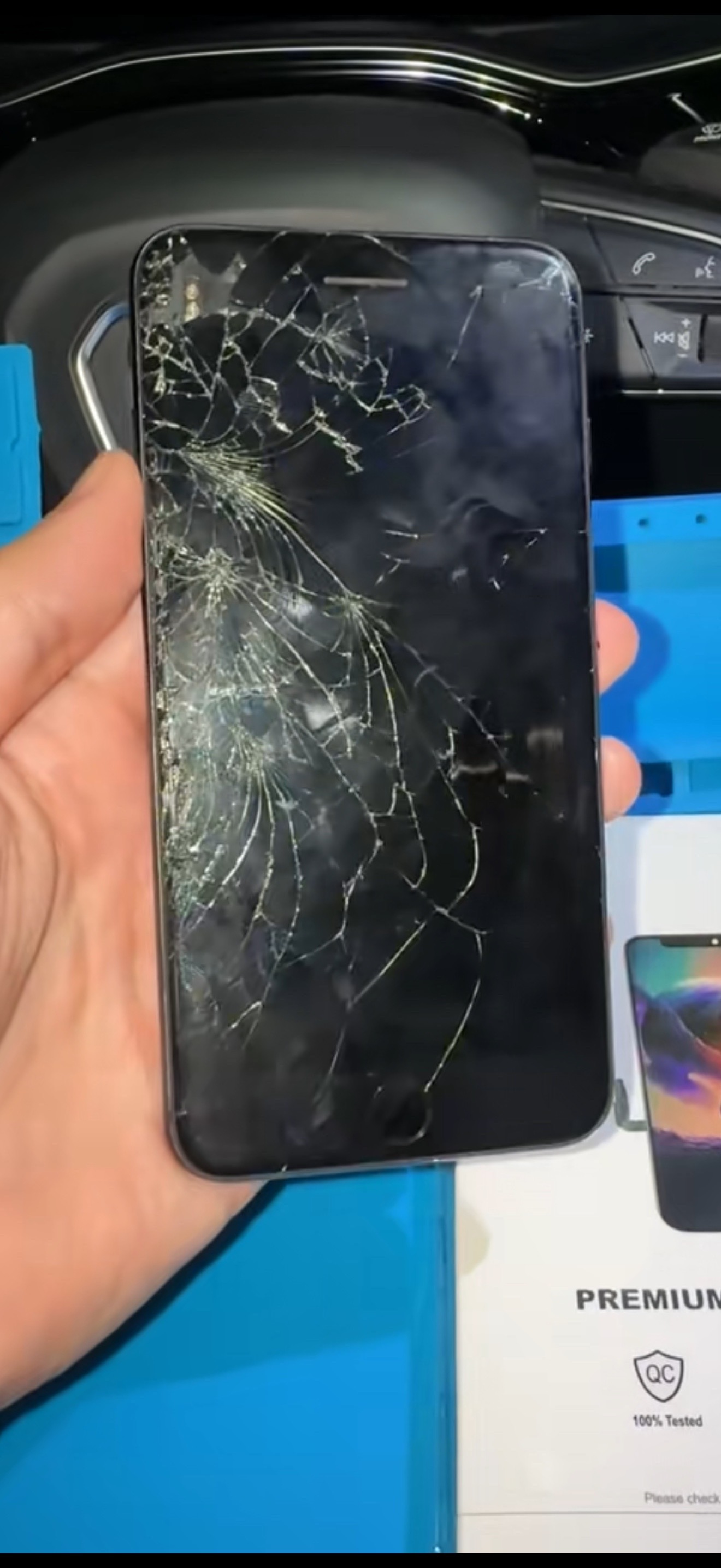 Before repair: older iPhone with severely cracked front glass